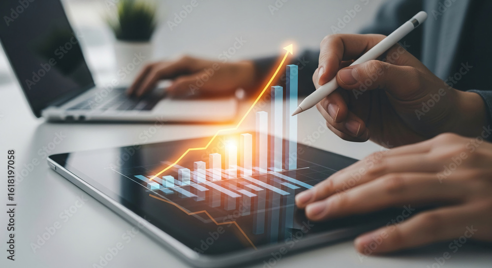 Poster close-up of hands using stylus on tablet displaying upward trending bar graph, showcasing business g