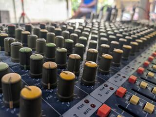 Close-up of audio mixer faders in recording studio, electronic equipment for sound systems.
