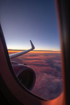 Fototapeta Scenic view from airplane window during sunset flight