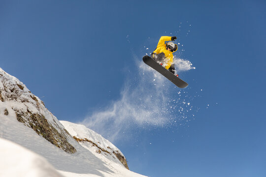 Snowboarder catching air in a backcountry freeride experience
