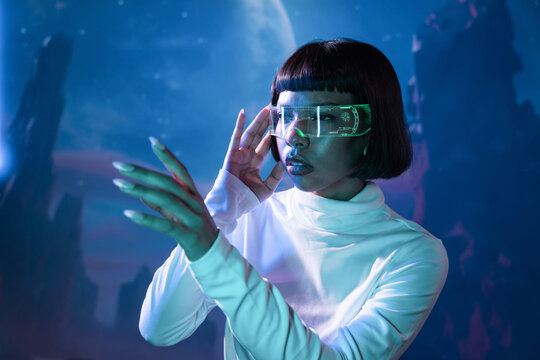 Latin woman exploring virtual reality in futuristic setting