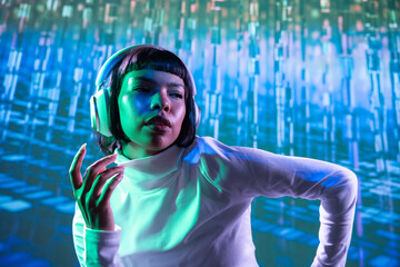 Futuristic woman enjoying music with headphones