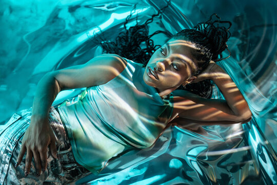 Futuristic young woman in a vibrant virtual landscape