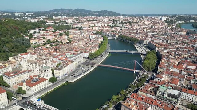 Aerial view of the city, with its terracotta rooftops contrasting against the deep blue river Sa&ocirc;ne and the bridges that cross it, Lyon, Auvergne-Rh&ocirc;ne-Alpes, France.