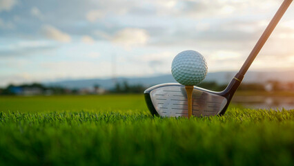 Close-Up of Golf Ball on Tee with Club in Background at Sunset