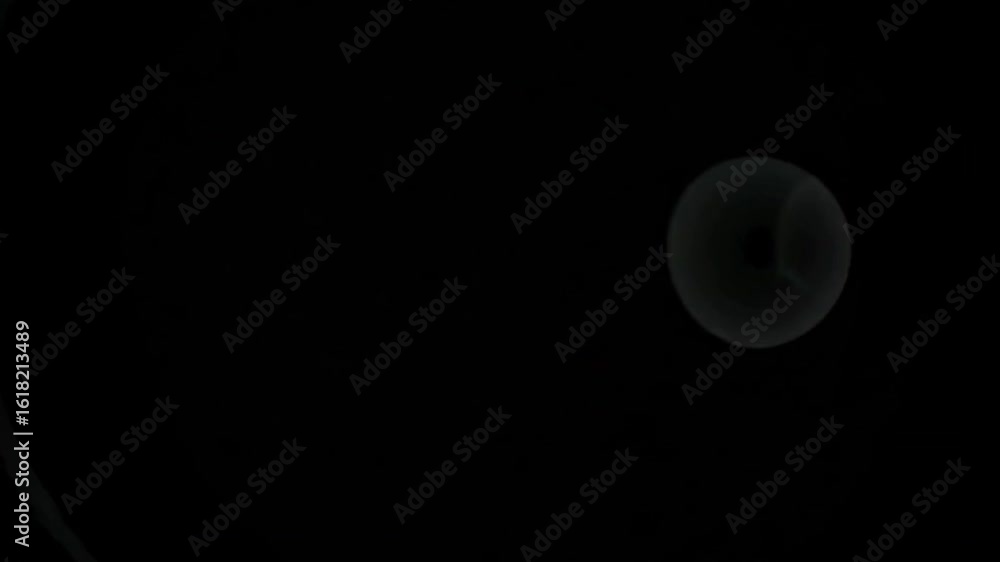Poster mysterious sphere in black void. a captivating image featuring a single, glowing sphere suspended ag