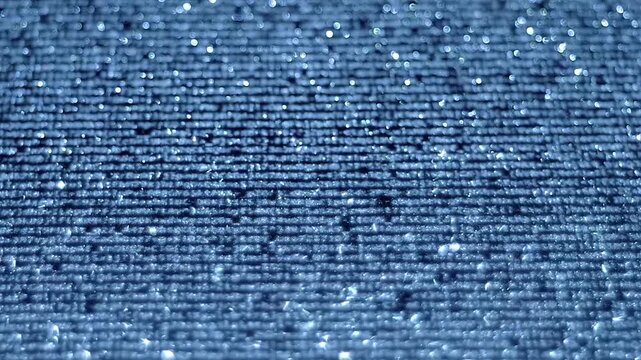 Animated lines of text or program code move across a shiny, sparkling surface. Closeup. Macro. Follow focus. Shallow depth of field