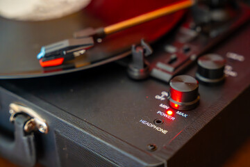 Close-up of record player needle tracking vinyl grooves during playback. Analog sound detail...