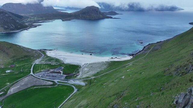 Calm midnight sun view of Haukland Beach from Mannen mountain ridge, Lofoten, Norway