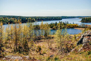 Landscape blue deep lake light sun, clouds sky mountains Ladoga skerries Karelia
