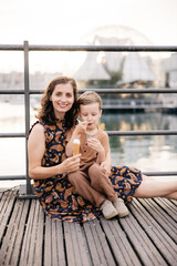Mother and son eating ice cream in genoa, italy, during summer holidays