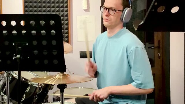 drummer playing in a recording studio .young man asian drummer rehearsing diligently concentrated playing recording studio drums