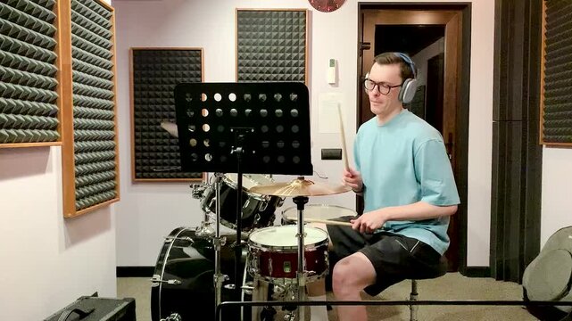drummer playing in a recording studio .young man asian drummer rehearsing diligently concentrated playing recording studio drums