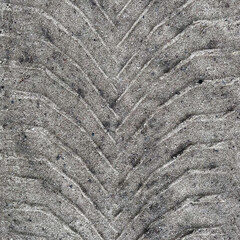 Chevron tire print on moist sand surface, square closeup background texture