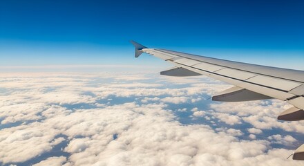 Fototapeta premium Airplane wing view from flight above clouds travel transportation and sky tourism