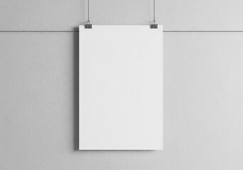 Blank white poster hanging on a gray wall, secured with metal clips, with a minimalist and modern aesthetic.