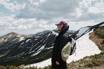 Hiker Admiring Snowy Mountain View in Svydovets Range, Ukraine