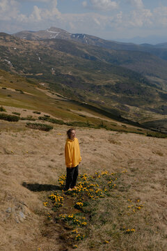 Woman in Yellow Jacket Hiking in Carpathian Mountains