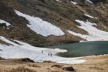Hikers Exploring a Serene Mountain Lake in Svydovets Range, Ukraine