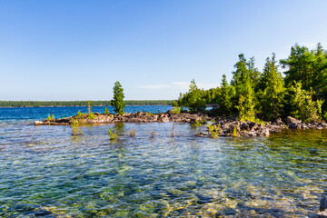 Wild rocky shoreline of Bruce Peninsula National Park near Little Dunks Bay. Lake Huron, Tobermory,...