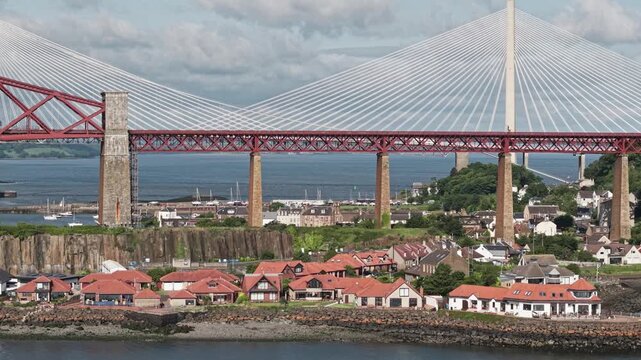 Aerial, North Queensferry waterfront houses and Forth Bridge, Scotland