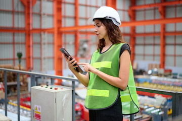 Engineer or technician working on tablet in the factory