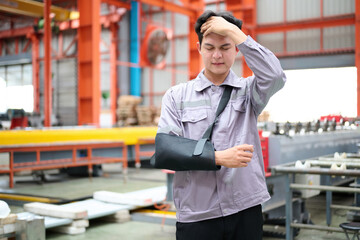 Engineer or worker wearing bandages splint, pain in elbow and ache in arm from hard work in the factory