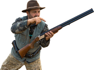 Mature hunter man holding a shotgun and walking through a field