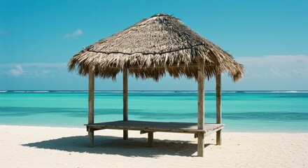 Simple thatched beach hut on white sand beach, turquoise water