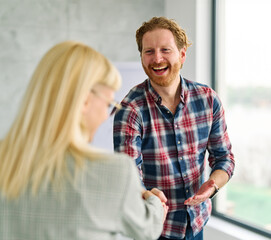 Group of young business people having a meeting shaking hands handshake introducing each other...