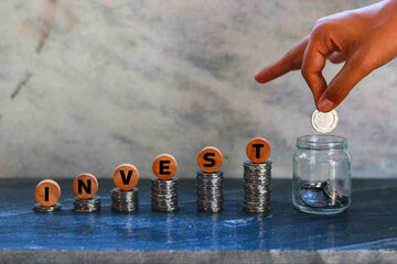 Coins stacked on each other forming the word VAT. The concept of increasing income.