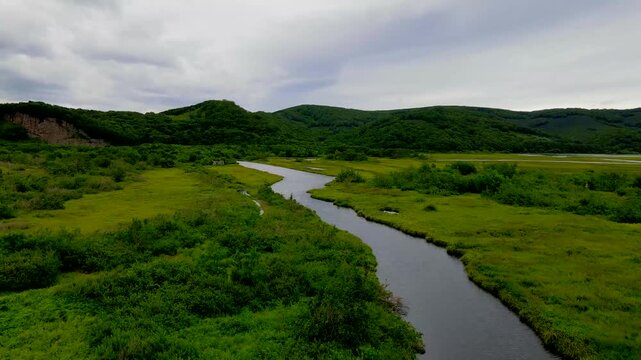 The scenic river in Kamchatka Peninsula with the greenery landscape of the remote Russian Far East region.
