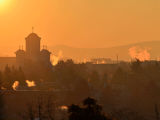 A cold winter morning in the Tudor neighbourhood of Targu Mures, with smoke rising from the...