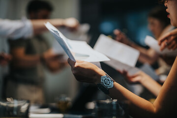 Dynamic group interaction in a modern workspace emphasizing teamwork and document analysis.
