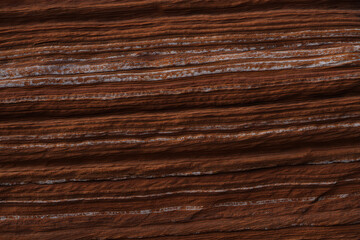 Fototapeta premium Closeup view of dark brown wood grain texture with visible lines and patterns