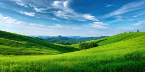 Fototapeta premium Rolling green hill landscape under blue sky with soft clouds and warm breeze creating peaceful nature scene