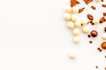 Candy background with chocolate on white table top view frame. Sweets desserts concept. Space for text