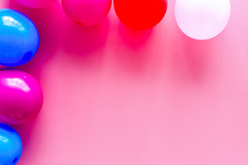 Decorative frame with colorful balloons on pink background top-down frame copy space