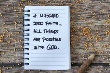 Mustard seed faith handwritten Christian text in notebook on wooden table. Top view. Trust and belief in God Jesus Christ, biblical concept.