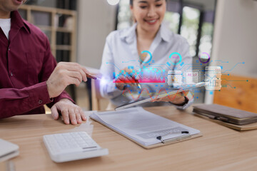 Businessman and woman holding digital tablet with futuristic interface for analytics data dashboard.