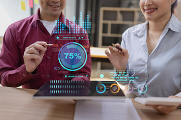 Businessman and woman holding digital tablet with futuristic interface for analytics data dashboard.