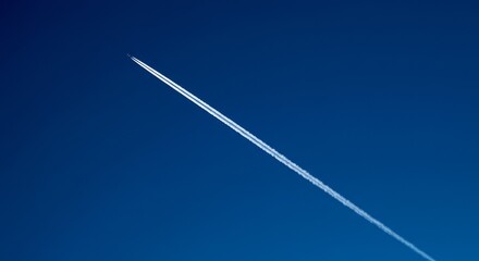 Illustration of jet contrail in the clear blue sky on a sunny day