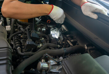 The repairman is repairing the car