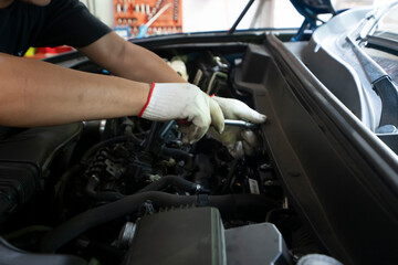 The repairman is repairing the car