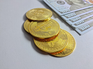 Gold bitcoins and banknotes on white background. Business concept.