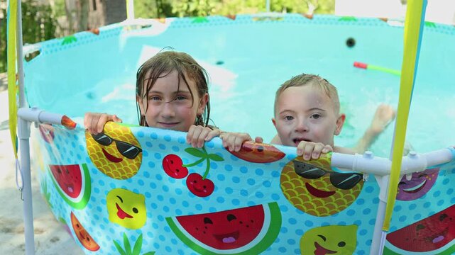 Children playing in the pool. Summer, vacation, joy, happiness. 