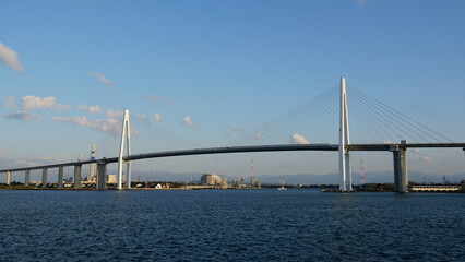Fototapeta premium Toyama Port under Blue Skies: Bridges and Sails over the Japan Sea