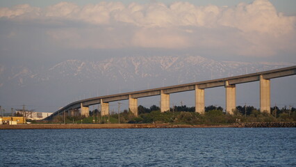Fototapeta premium Toyama Port under Blue Skies: Bridges and Sails over the Japan Sea