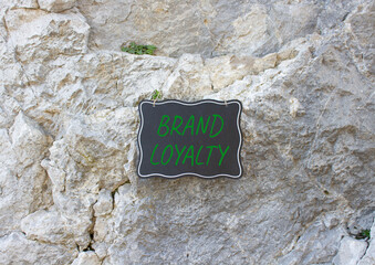 Brand Loyalty symbol. Stone wall with words Brand Loyalty. Beautiful stone background. Business and...