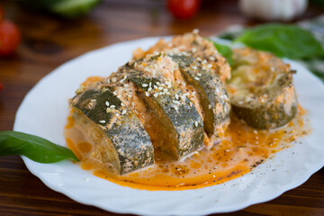 Baked zucchini with cheese and sesame in a creamy sauce